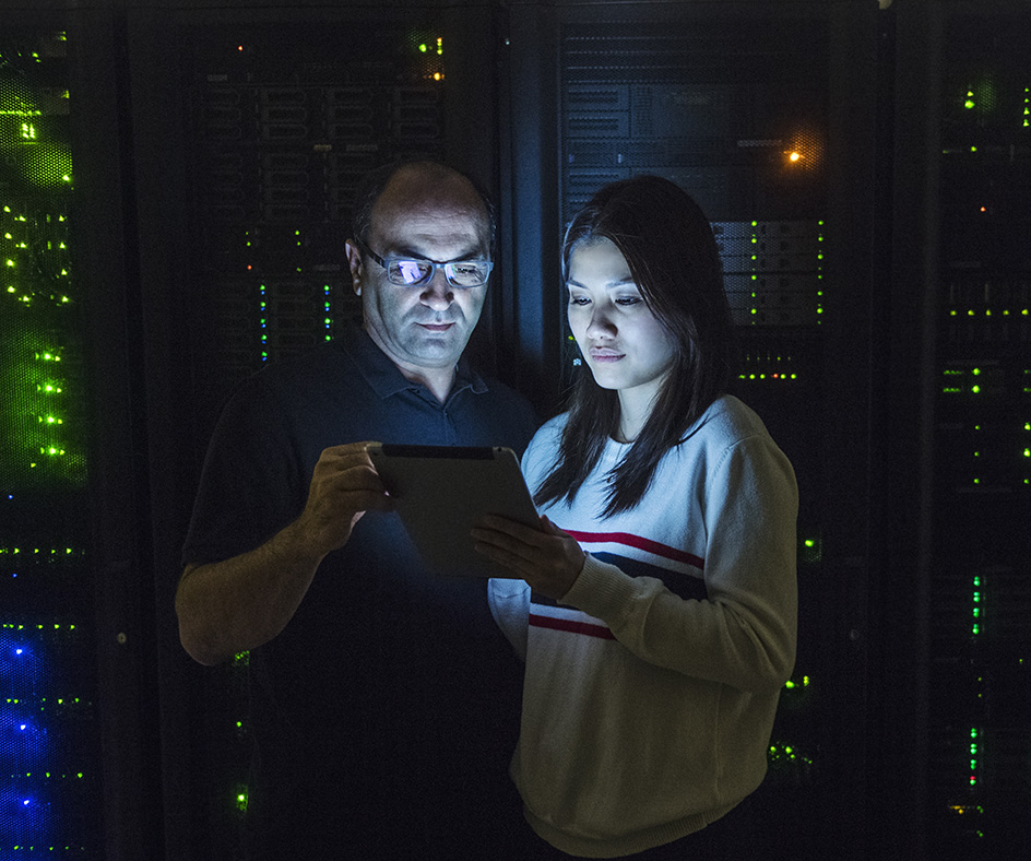 IT professionals collaborating in a data center, representing private managed cloud management