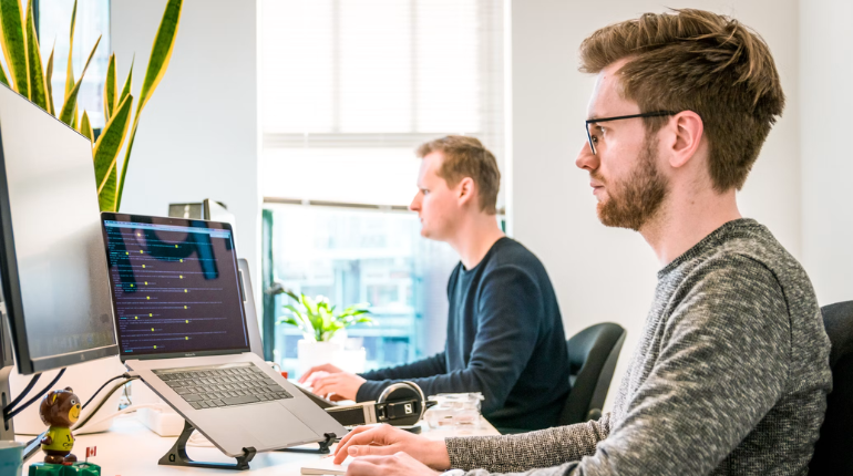 Software developers working on digital factory solutions in a modern office